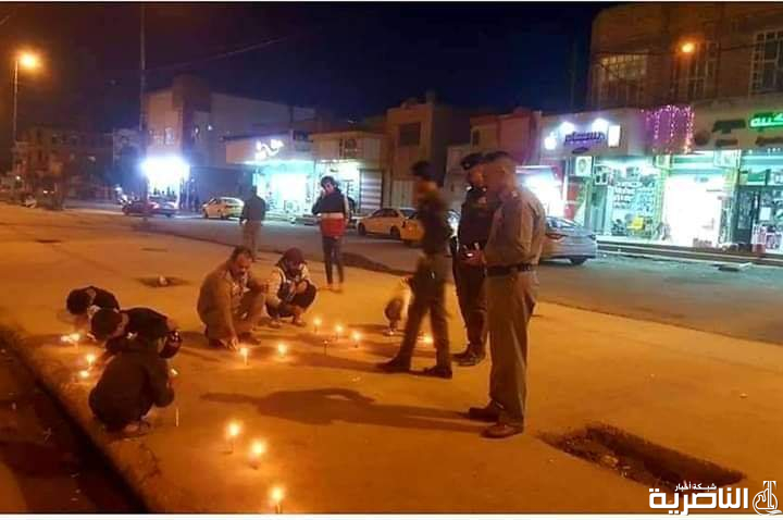 بالصور: شرطة الناصرية توقد الشموع حزنا على شهداء التظاهرات