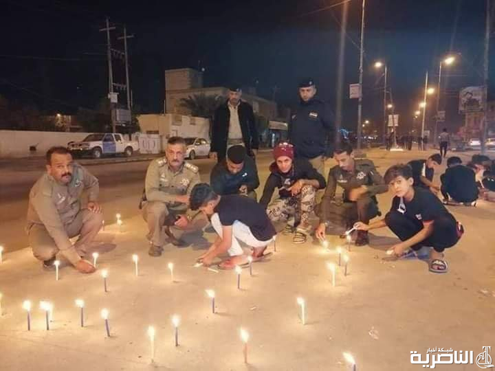 بالصور: شرطة الناصرية توقد الشموع حزنا على شهداء التظاهرات
